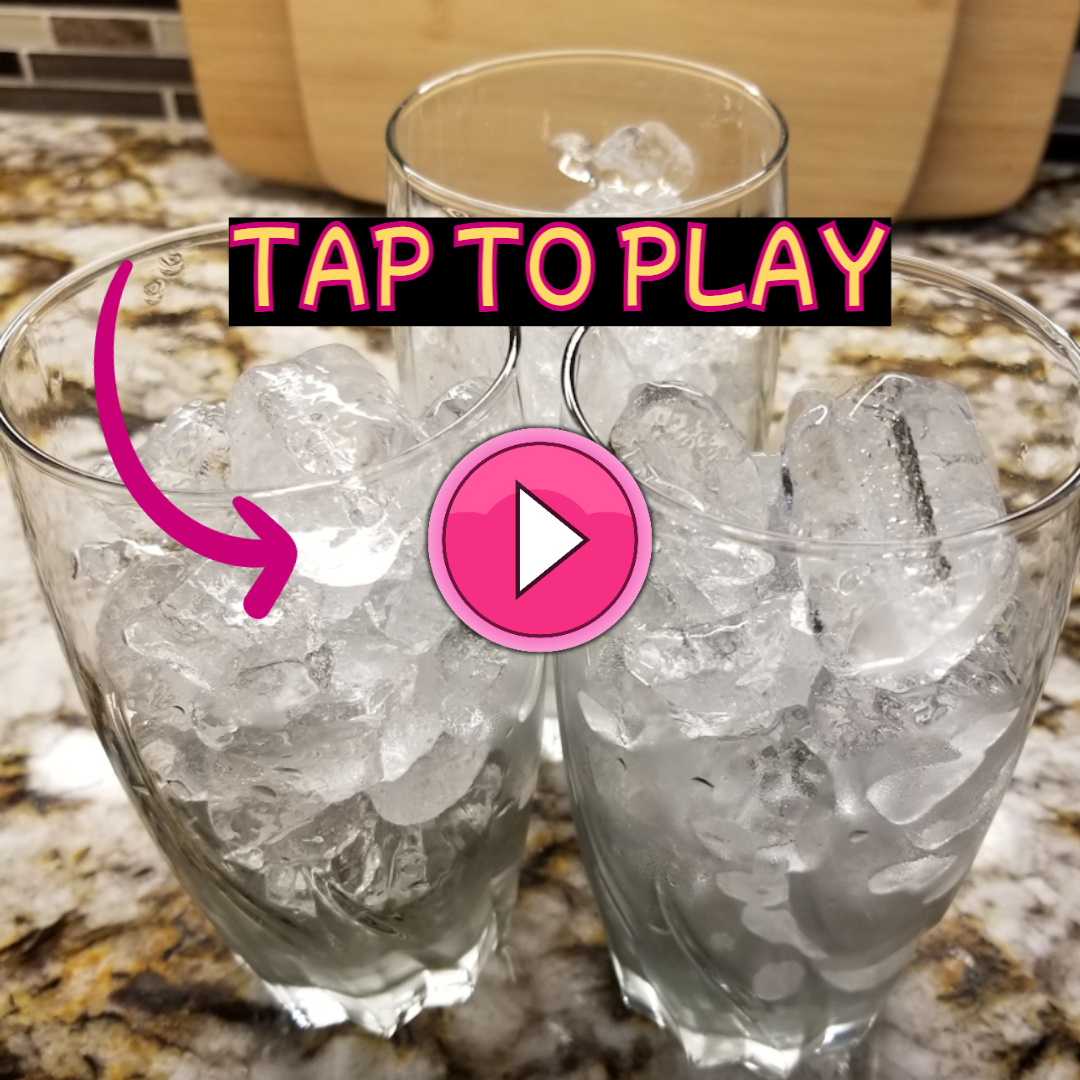 Pink play button on ice cubes